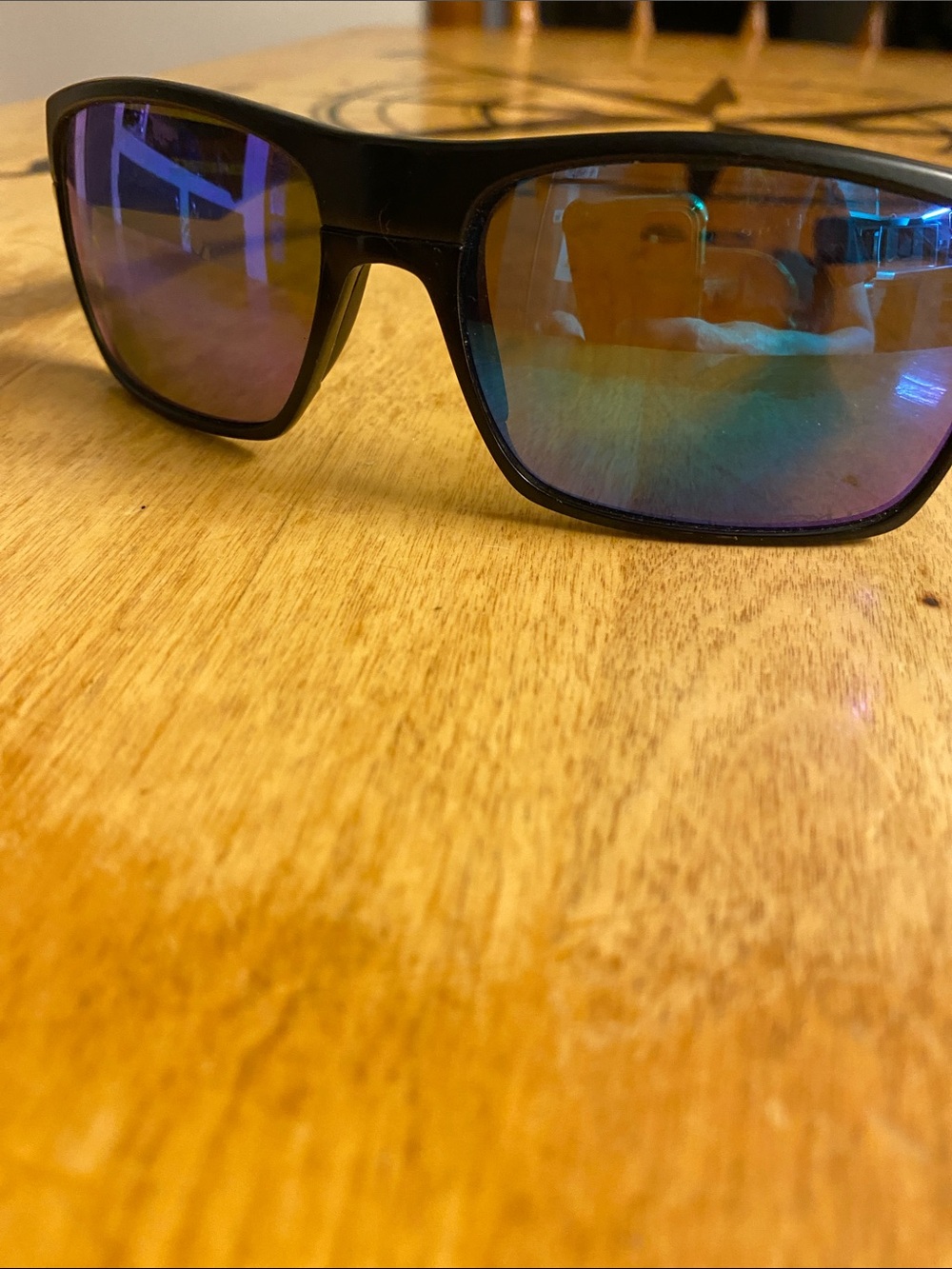 Oakley Black Frame Sunglasses with Blue-Purple Mirrored Lenses